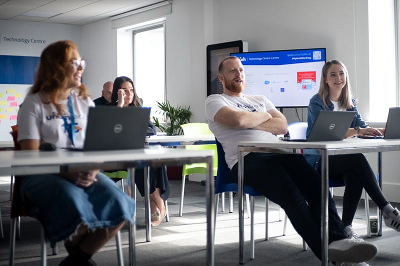 Several Unum Group employees sitting at desks at a training
