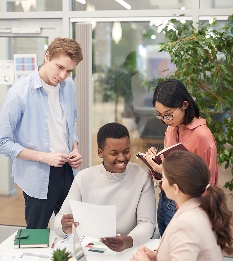 Group of employees sitting at a table during a meeting