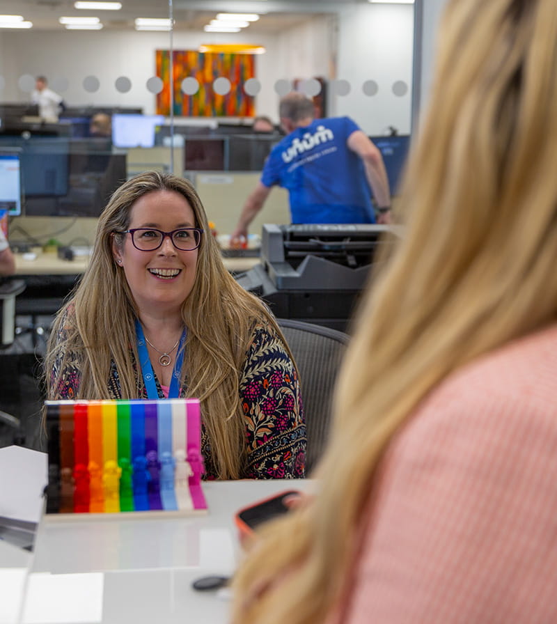 2 women in the Unum Ireland office talking to each other