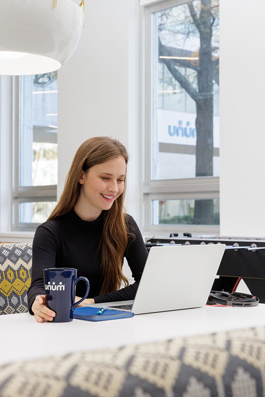 A female employee with a laptop open in front of her