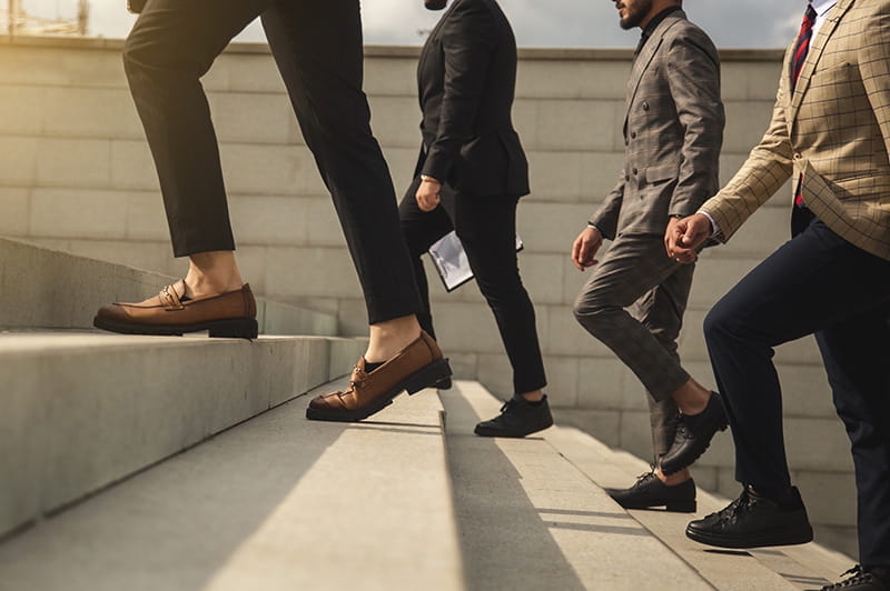 Group of people walking up steps